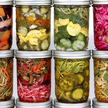 Load image into Gallery viewer, Ten mason jars filled with colorful pickled vegetables, including cucumbers, carrots, radishes, and herbs like dill, and sunflower microgreens, are neatly arranged in two rows against a white background.