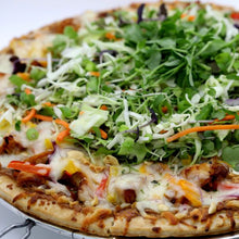 Load image into Gallery viewer, A pizza with a golden crust is topped with melted cheese, chunks of chicken, colorful bell peppers, and a vibrant salad mix of shredded cabbage, carrots, and microgreens.