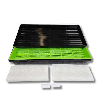 Green and black plastic tray with white filters on a white background