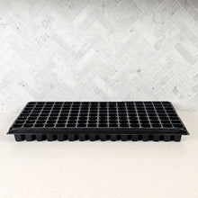 Cargar imagen en el visor de la galería, Single On The Grow 128-cell plug tray with 1-inch cells for seed starting, shown from the side against a marble tile wall
