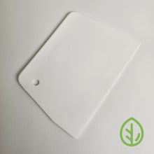 Load image into Gallery viewer, On The Grow microgreen grow medium scraper and cleaning tool in white, used to remove roots from reusable silicone grow mediums
