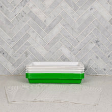 Load image into Gallery viewer, Small sprouting tray set with reusable silicone grow mediums stacked on a countertop against a marble tile wall
